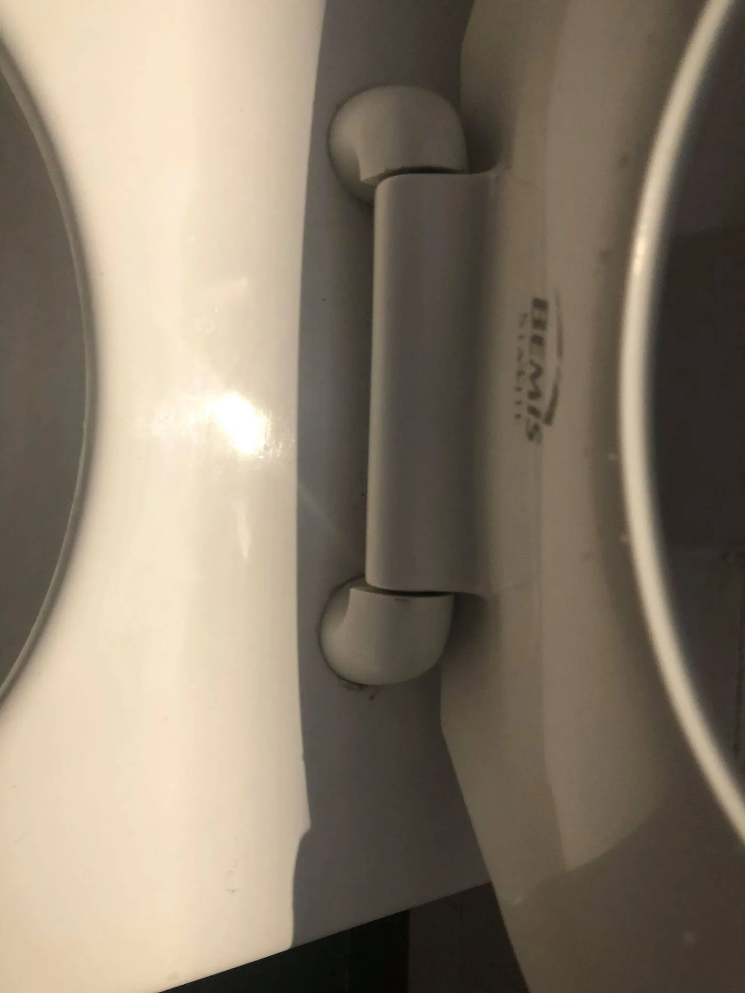Close-up of a toilet seat hinge